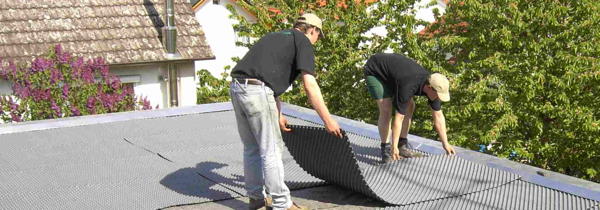 Foto: Zwei Männer beim Aufbau einer Dachbegrünung