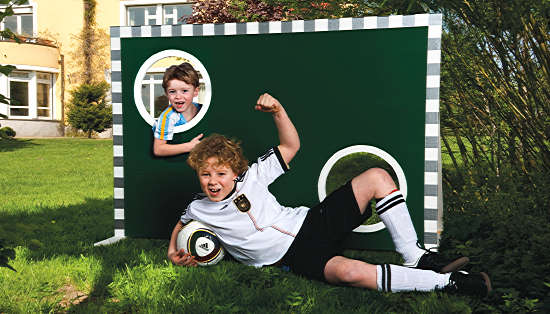 Zwei Jungen im Fußball-Trikot mit der Torwand